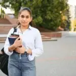 portrait-of-indian-girl-student-with-books-near-university-photo